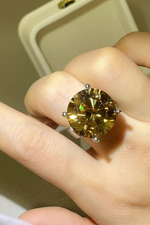 Gold radiant cut moissanite cocktail ring with large round center stone.