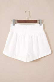 White ribbed-waist high rise relaxed shorts with a-line cut.