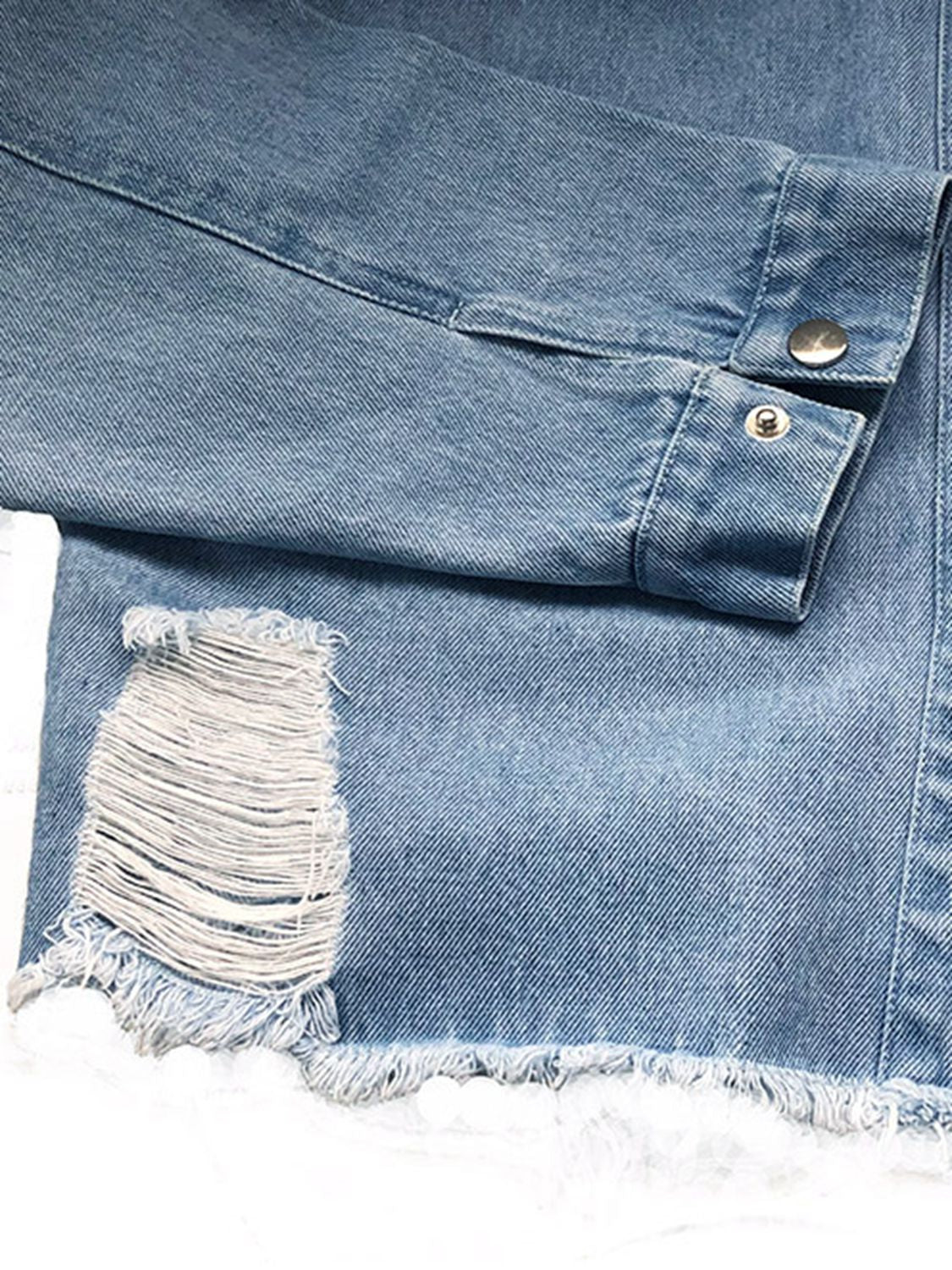 Light wash denim shirtdress with distressed rip and raw hem detail.