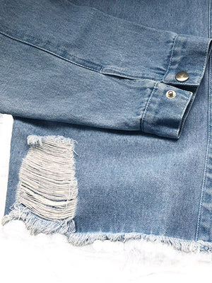 Light wash denim shirtdress with distressed rip and raw hem detail.