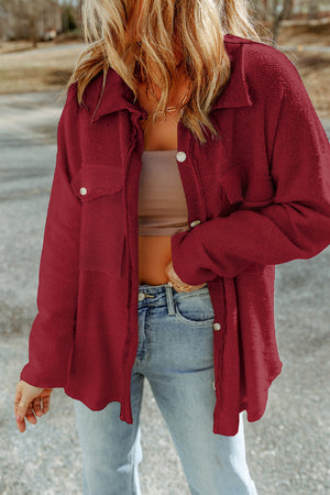 Burgundy textured shacket with raw edge detailing and button closure.