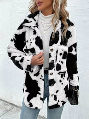 Cow print plush shacket in white and black with button front and chest pockets.