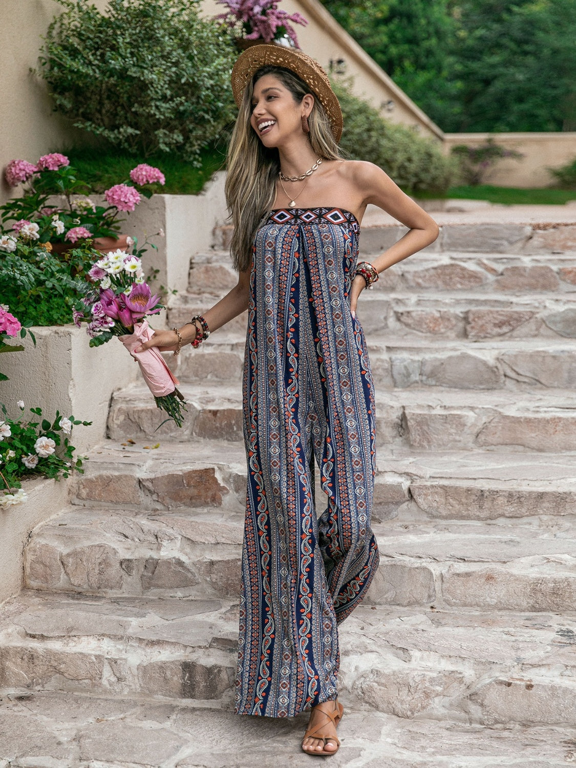 Boho bandeau jumpsuit with wide legs and a blue, orange, and white floral pattern.