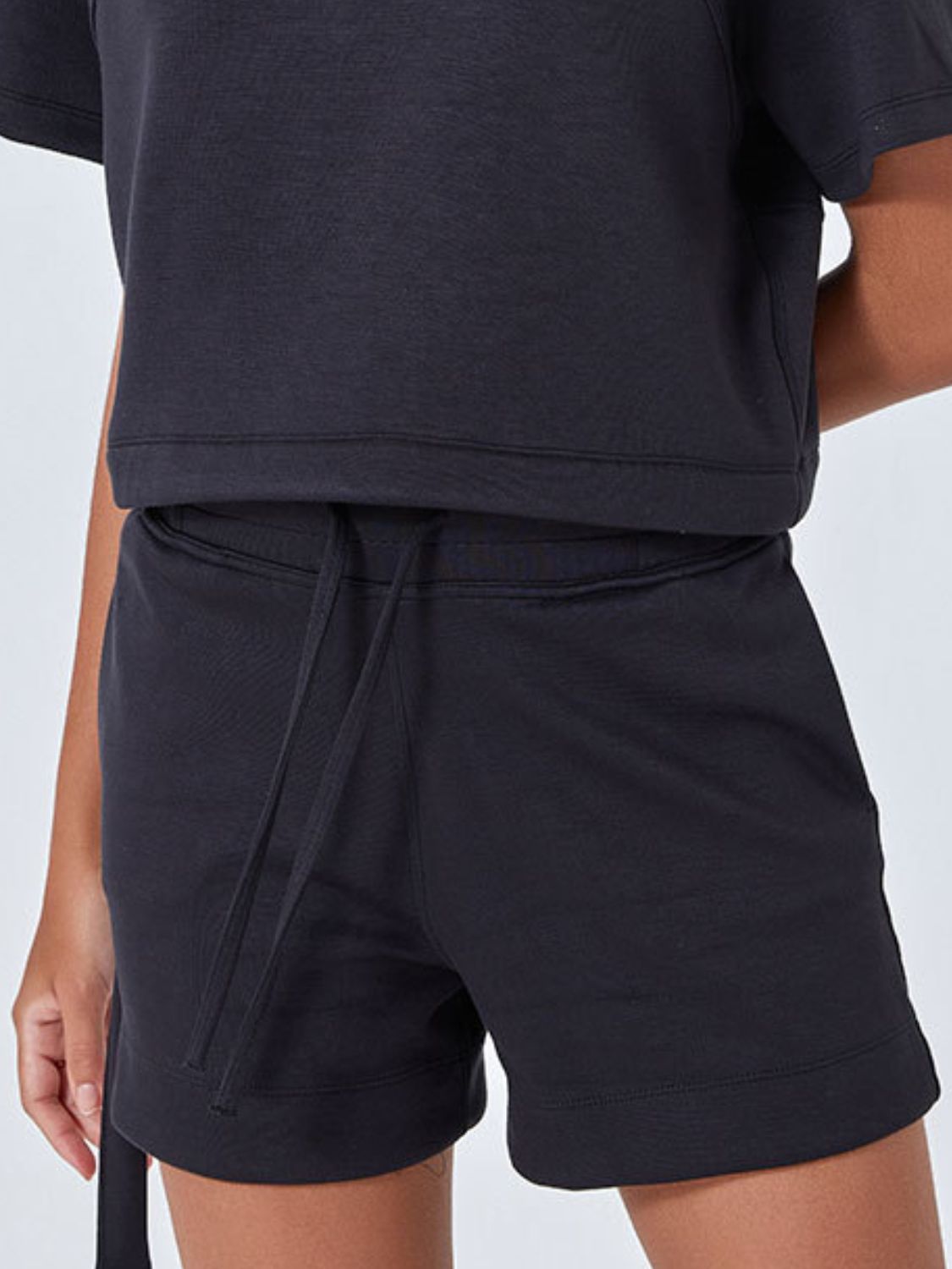 Black drawstring pocket shorts with a comfortable casual fit.