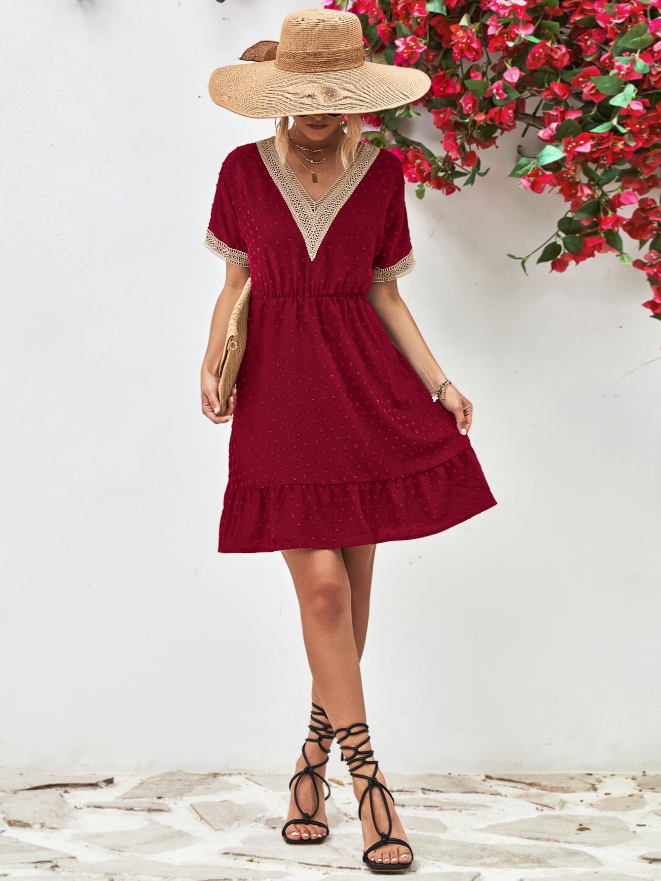 Burgundy textured Swiss dot dress with crochet trim V-neck, short sleeves, and tiered hem.