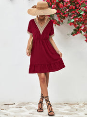 Burgundy textured Swiss dot dress with crochet trim V-neck, short sleeves, and tiered hem.