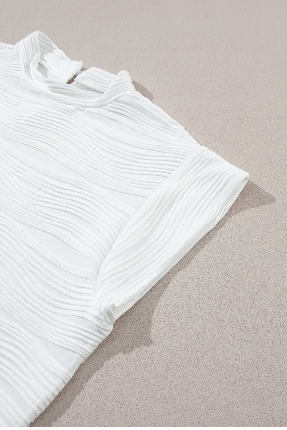 White textured wave cap-sleeve mock neck top with a chic casual style.