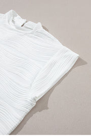 White textured wave cap-sleeve mock neck top with a chic casual style.