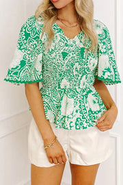Green floral smocked v-neck polyester overshirt with ruffled sleeves
