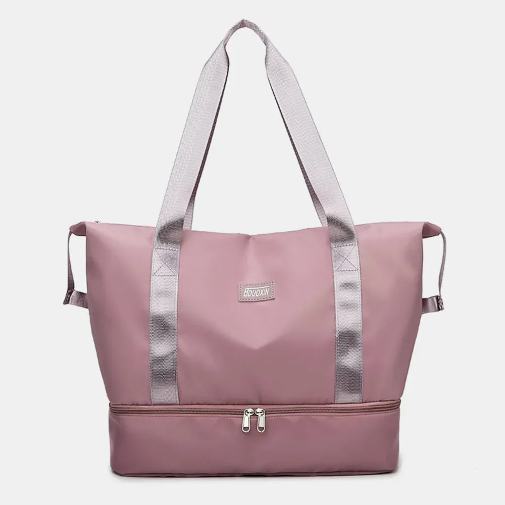Dusty Pink dual-compartment travel tote bag with metallic trim and dual zippers.