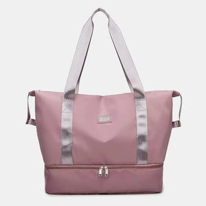 Dusty Pink dual-compartment travel tote bag with metallic trim and dual zippers.