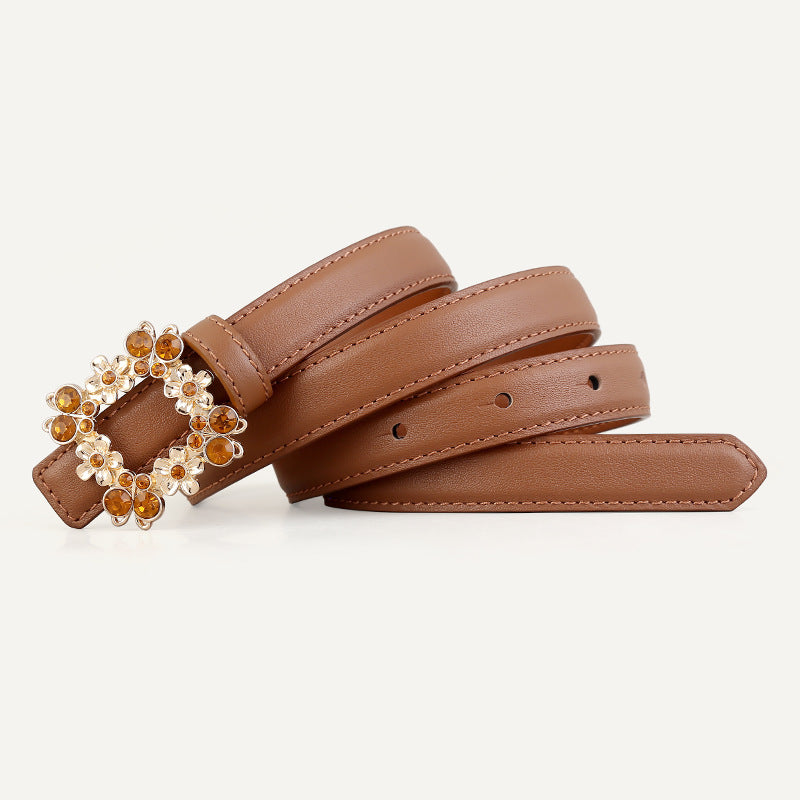 Caramel leather belt with ornate rhinestone-embellished buckle and gold accents.