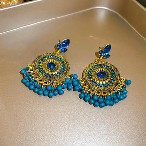 Cerulean beaded medallion and pearl drop earrings with gold alloy accents.