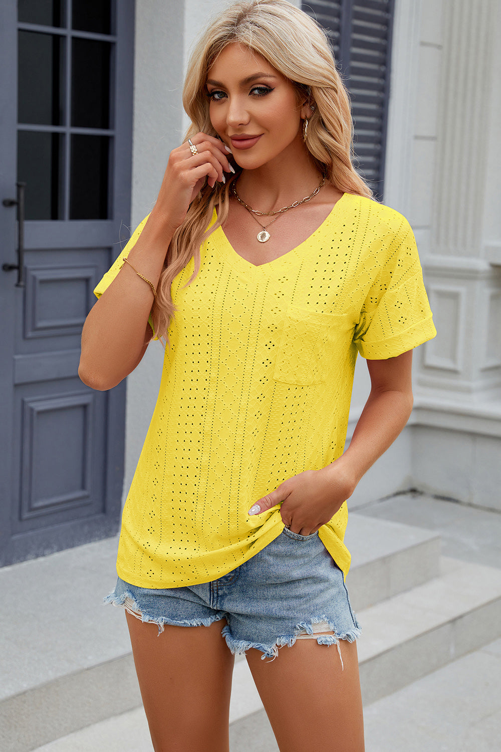 Yellow perforated pocket tee with rolled sleeves and V-neck.