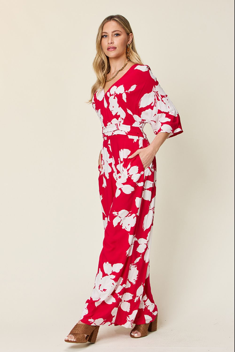 Red floral kimono jumpsuit with wide legs and v-neck.