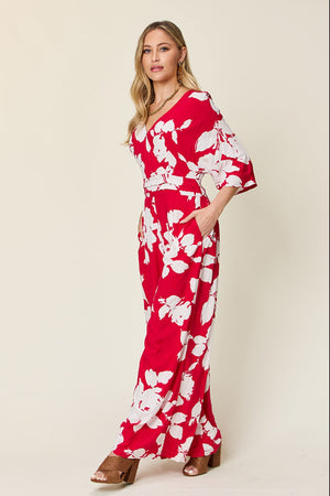 Red floral kimono jumpsuit with wide legs and v-neck.
