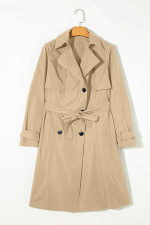 Classic trench coat in Dust Storm with a bow-tie waist and buttoned front.