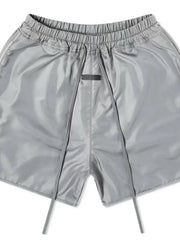 Nylon drawstring shorts in Dark Gray with a curved hem detail and elastic waistband.