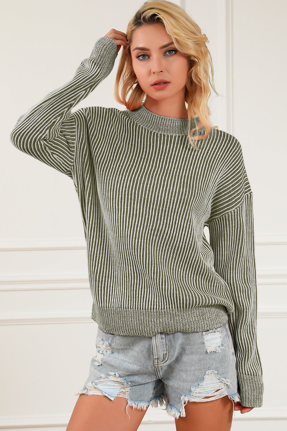 Green and white striped ribbed mock neck pullover sweater with long sleeves.