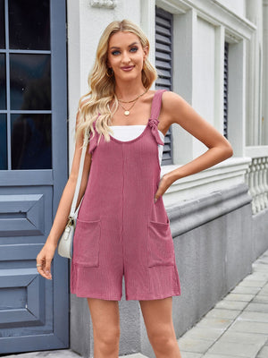 Deep Rose ribbed romper overalls with tie straps and front pockets.