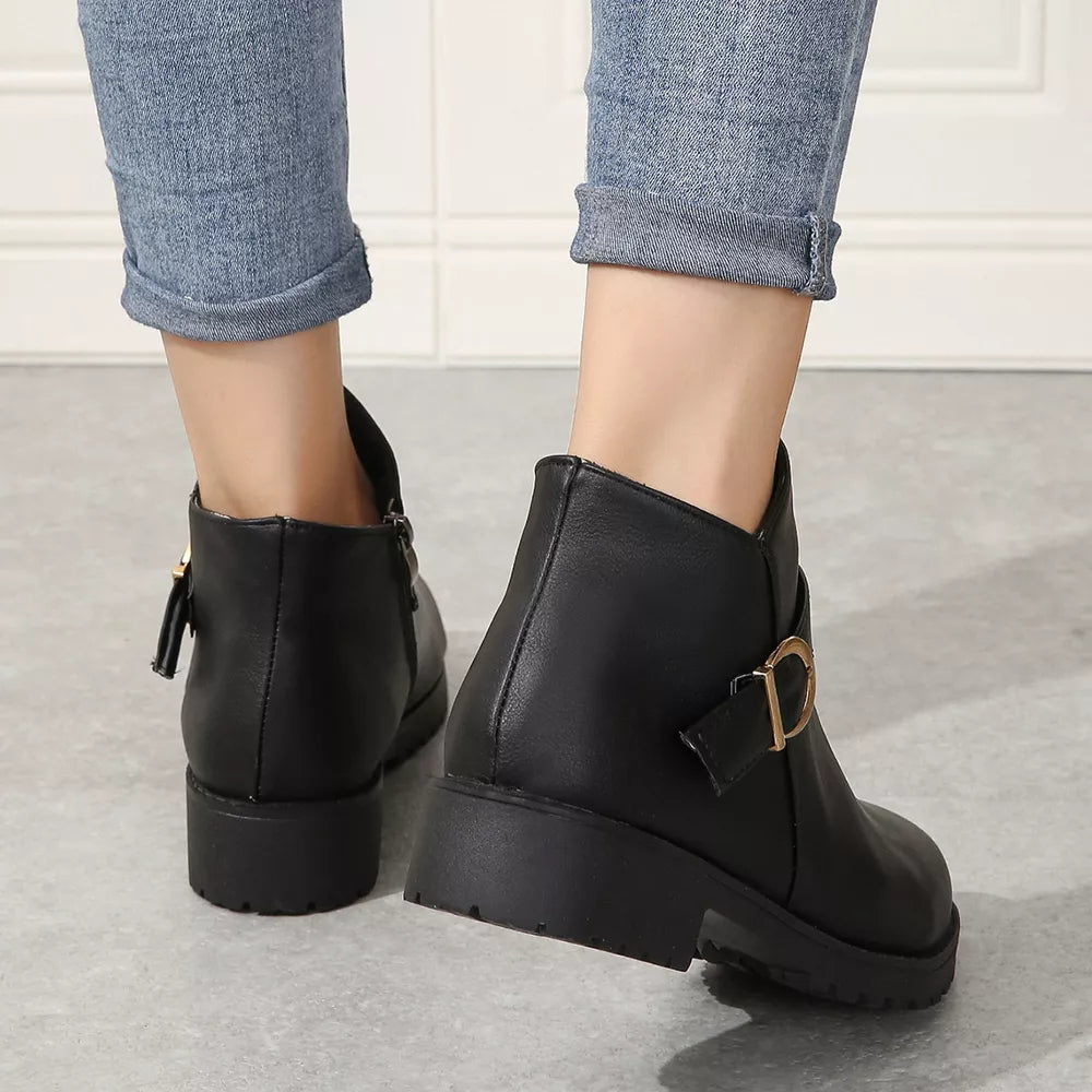 Black ankle boots with block heel and gold buckle detail.