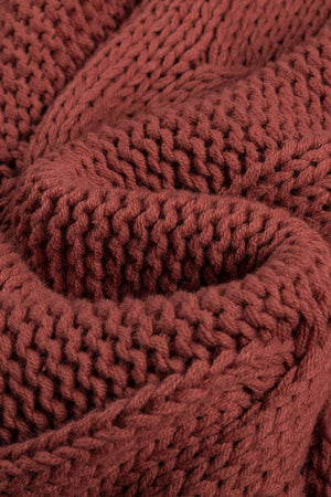 Cable knit turtleneck sweater in rust acrylic with a relaxed fit.