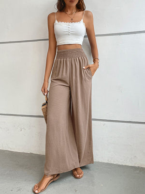 Brown textured smocked waist palazzo maternity pants with pockets.