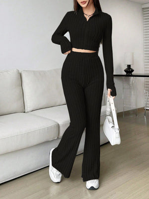 Black ribbed knit flare co-ord set with zip-neck crop top and high-waisted flared pants.