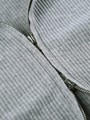 Grey ribbed knit hoodie detail with a silver zipper closure