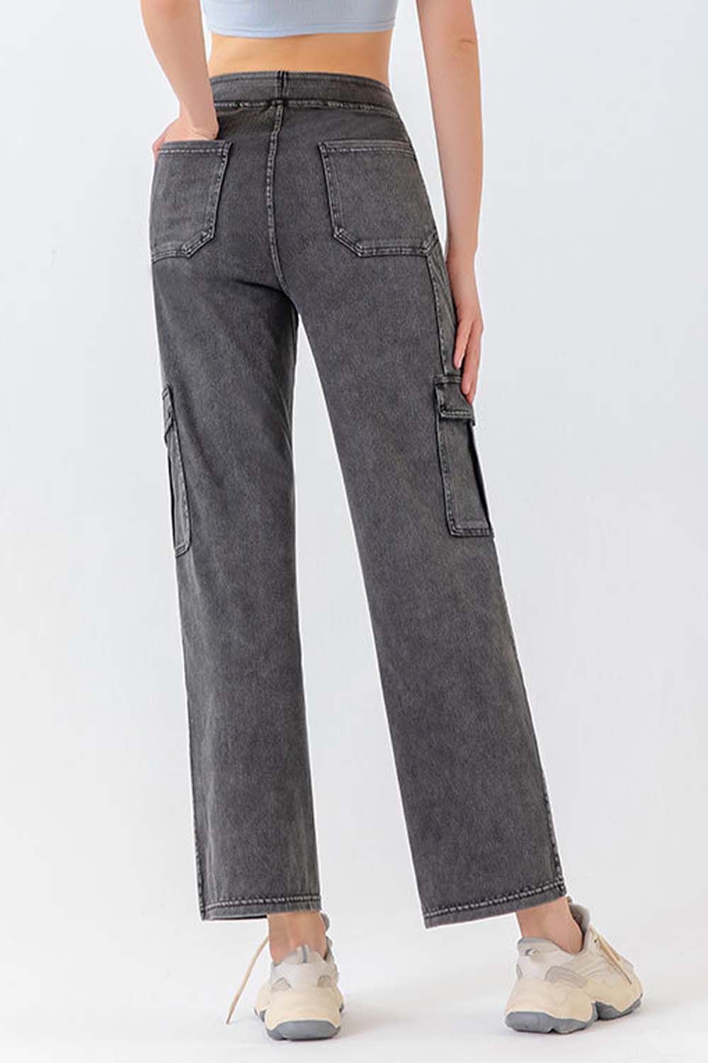 Gray denim cargo pants with utility pockets and a relaxed fit.