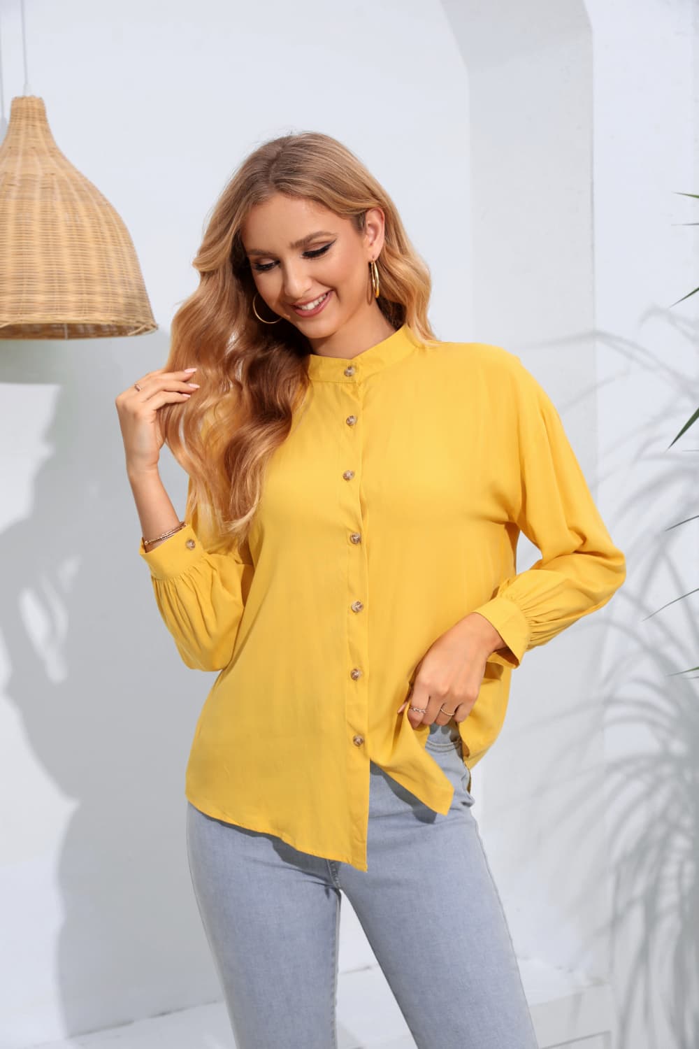 Mandarin collar yellow blouse with button front and gathered sleeves.