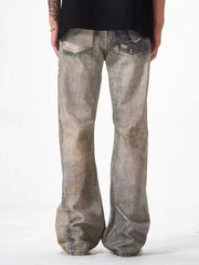 Men's loose-fit jeans in grey distressed cotton with heavy fading and rips.
