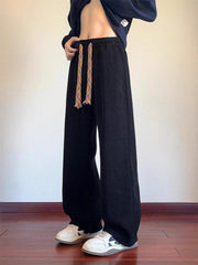 Men's black textured wide leg sweatpants with colorful drawstring detail.