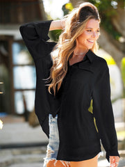 Black oversized linen beach shirt with button front and chest pockets, styled with denim shorts.