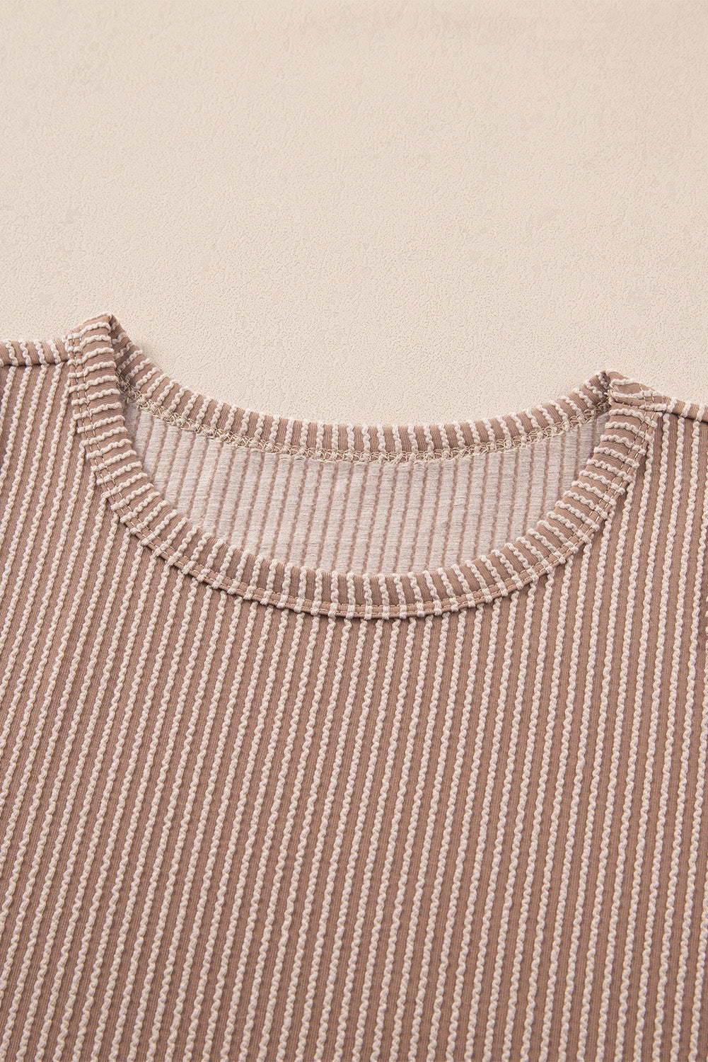 Tan textured stripe tank top with crew neck and ribbed trim.
