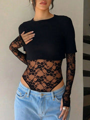 Black lace bodysuit with sheer floral sleeves and patchwork front, paired with jeans.