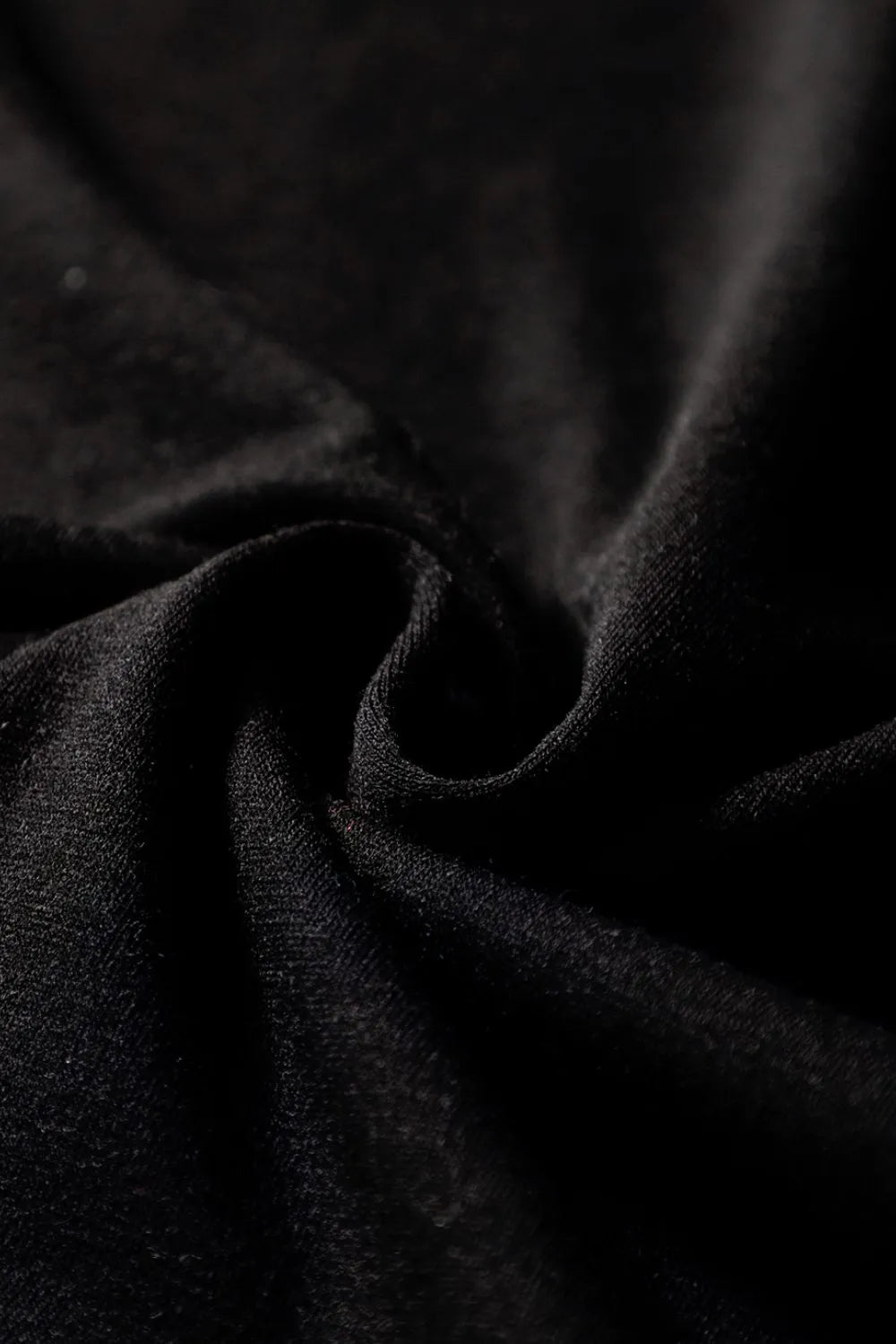 Black wide-leg jumpsuit with keyhole cutout detail and textured fabric.