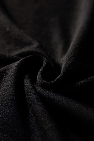 Black wide-leg jumpsuit with keyhole cutout detail and textured fabric.