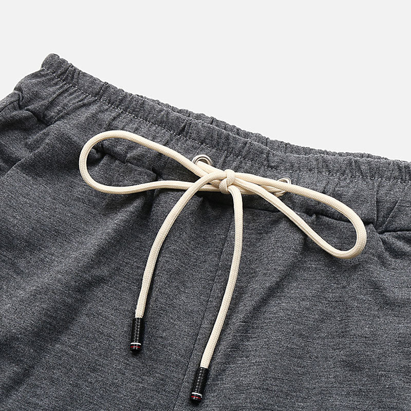 Relaxed culotte lounge shorts in charcoal grey with a drawstring waist and ribbed cuffs.
