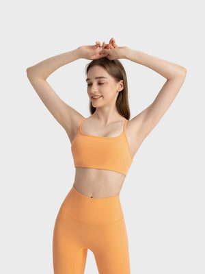 Strappy back active crop top in orange with a square neckline.