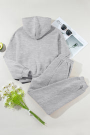 Gray relaxed fit lounge set with seam detail, featuring a hooded sweatshirt and sweatpants.