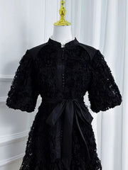 Black floral puff sleeve dress with button-down front and sash tie waist.