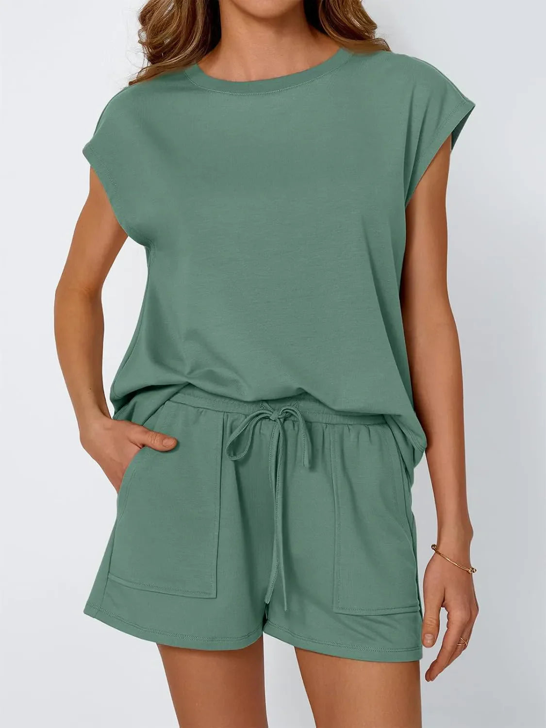 Relaxed green cap-sleeve drawstring loungewear set with shorts featuring pockets.