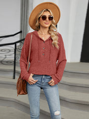 Rust ribbed knit henley hoodie with buttons and drawstring hood, casual long sleeve top.