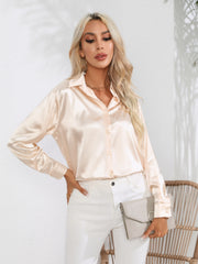 Blush pink satin tie-front blouse with buttoned front and collared neckline.