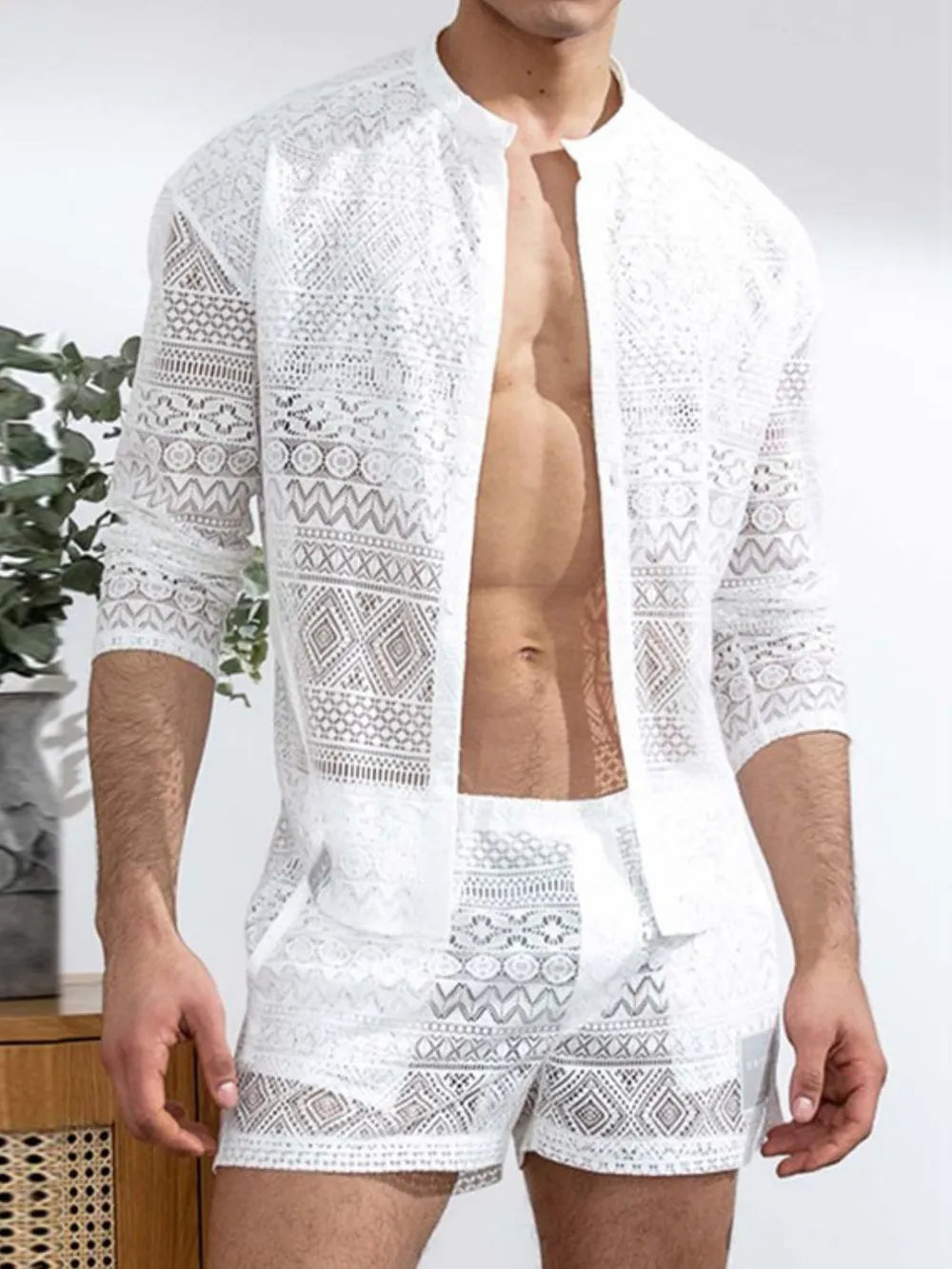 White open-weave crochet resort set with geometric patterns, long sleeves and shorts.
