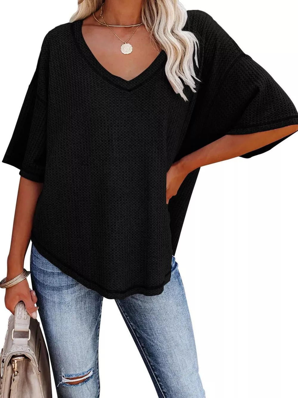 Black waffle knit relaxed v-neck t-shirt with short sleeves.