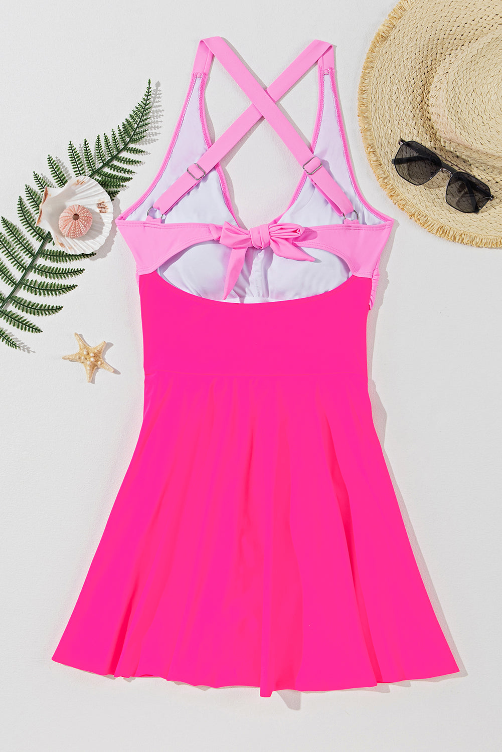 Hot pink one-piece swimsuit with cross-front and bow back detail