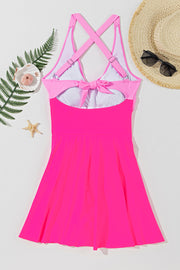 Hot pink one-piece swimsuit with cross-front and bow back detail