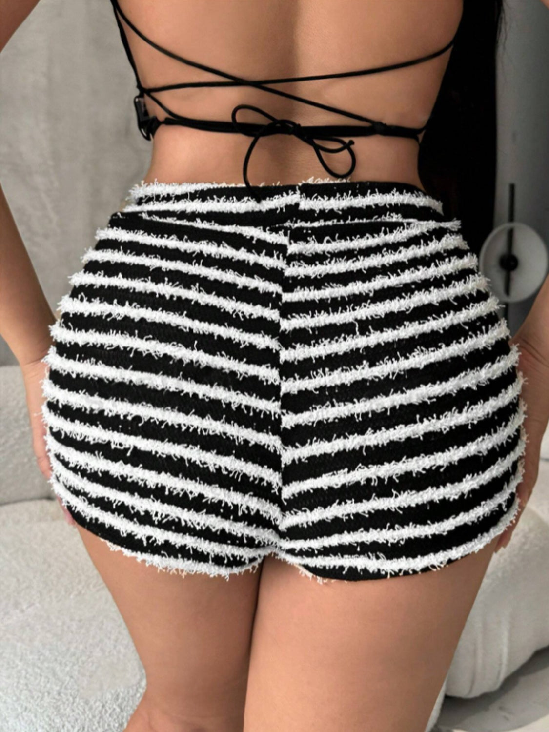 Textured stripe bouclé shorts in black with a fuzzy white stripe pattern and frayed hem.